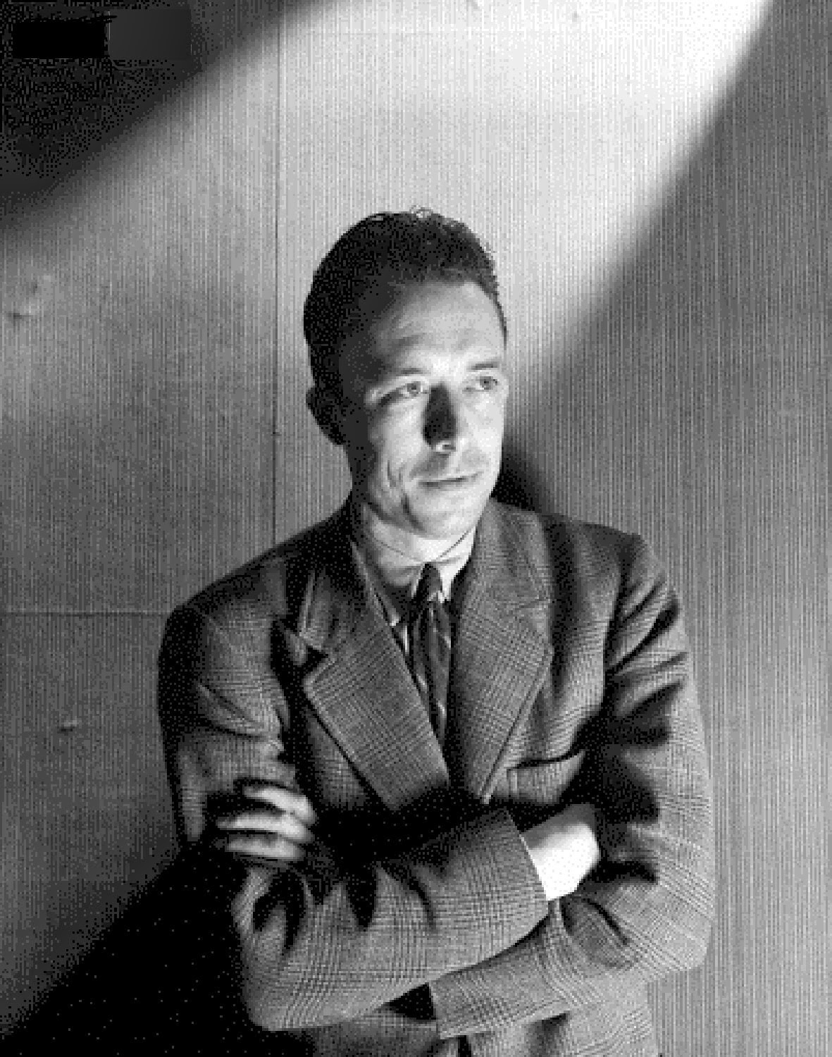 Circa June 1946, Paris, France --- French author and philosopher Albert Camus standing with his arms folded. Circa June 1946 --- Image by © Condé Nast Archive/Corbis